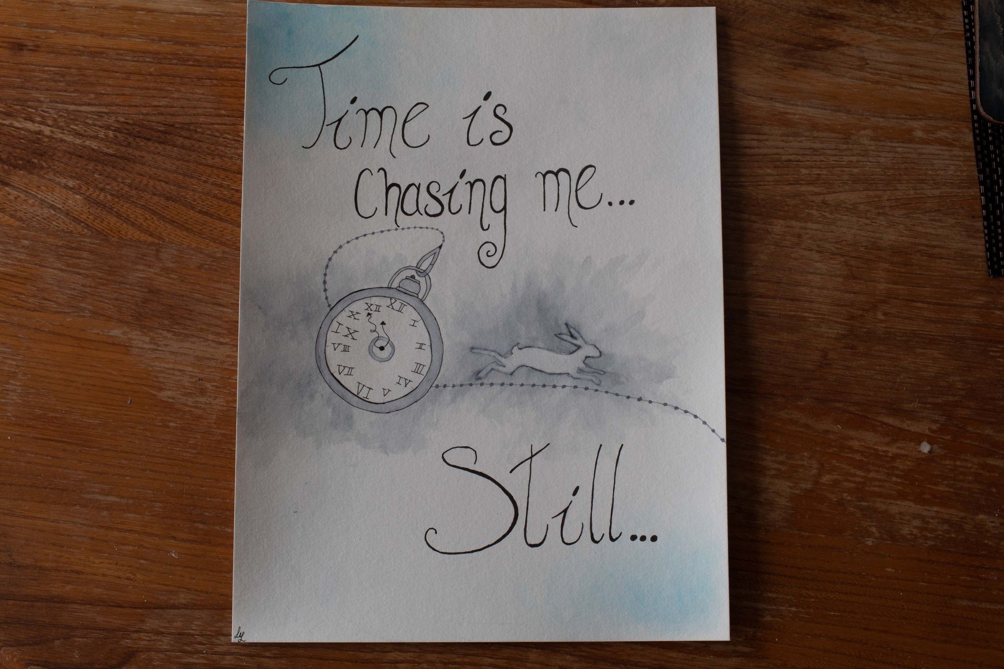 Product image of blue and white watercolour painting with white rabbit, pocket watch and text "Time is chasing me... Still", viewed closer up