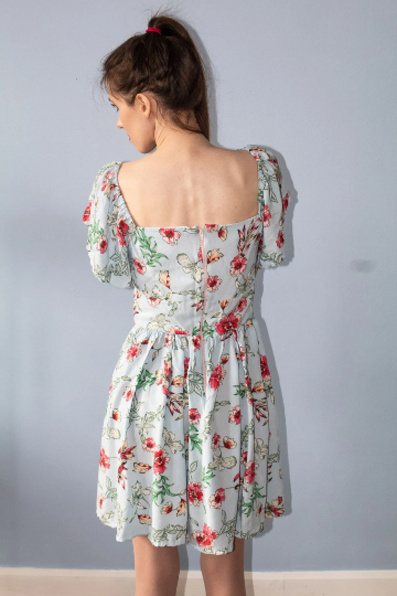 Product image of model wearing Callisto dress in floral print viewed from the back