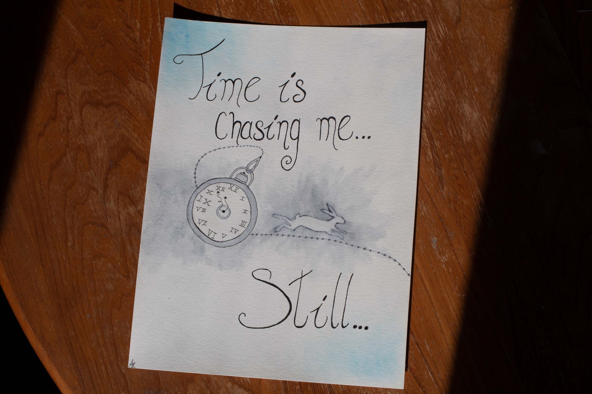 Product image of blue and white watercolour painting with white rabbit, pocket watch and text "Time is chasing me... Still", viewed from an angle